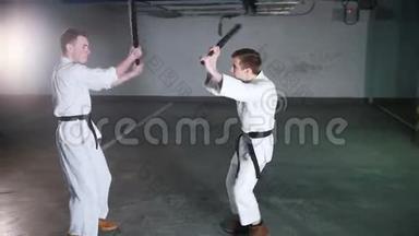两个穿和服的男人在停车场训练剑道